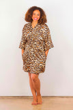 Woman wearing a leopard-print satin robe.
