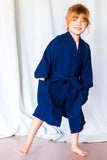 A child wears a navy youth robe.